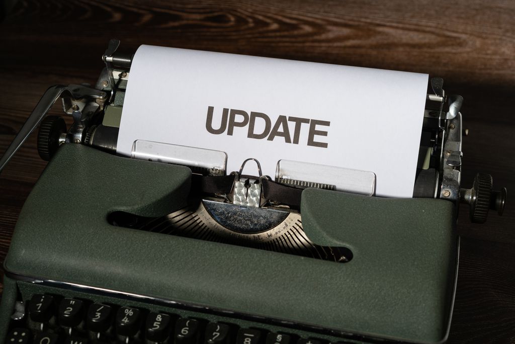Software Updates A close-up of a classic typewriter with a sheet displaying 'UPDATE' text, evoking nostalgia.