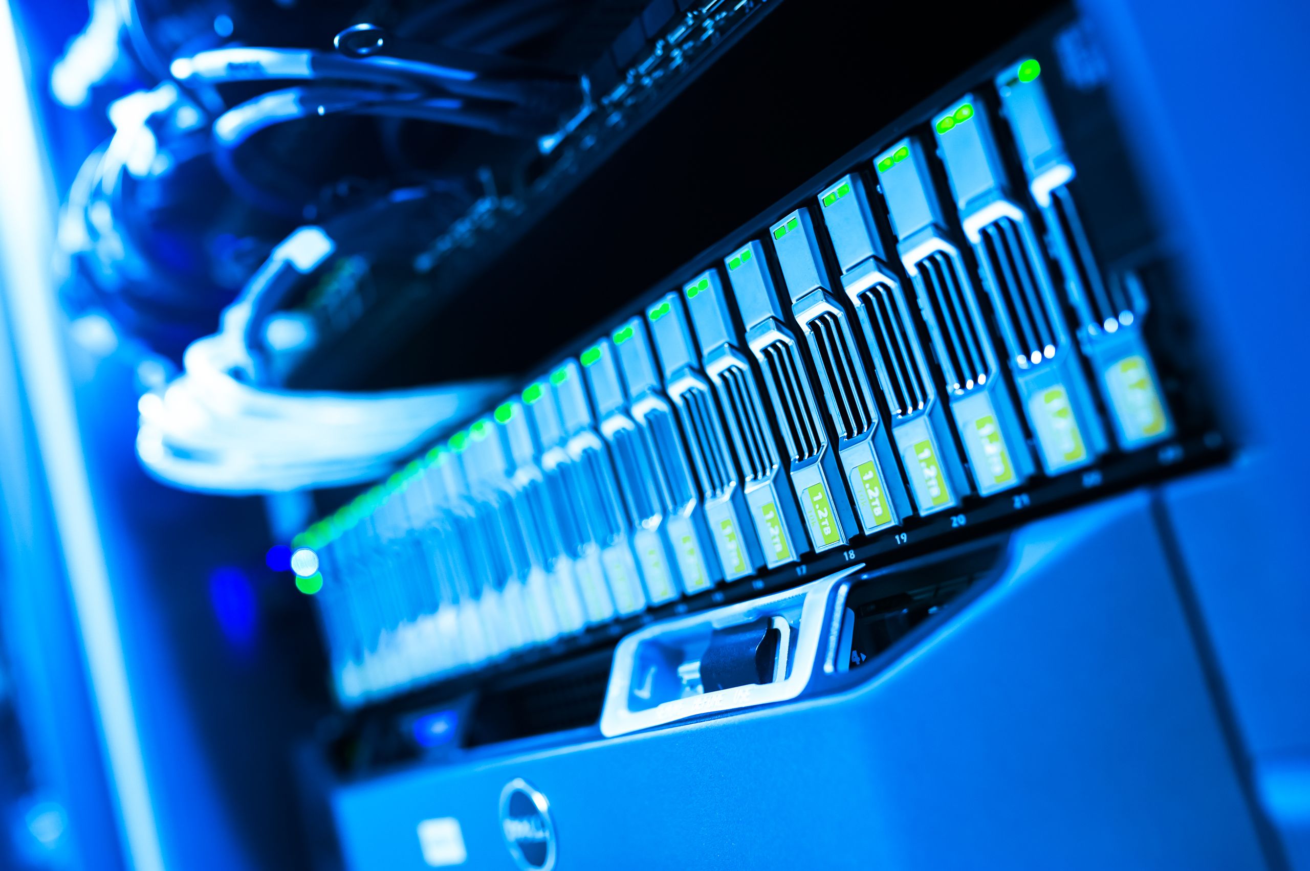 How AI Is Changing Cloud Computing and Data Centers in A detailed view of a blue lit computer server rack in a data center showcasing technology and hardware.
