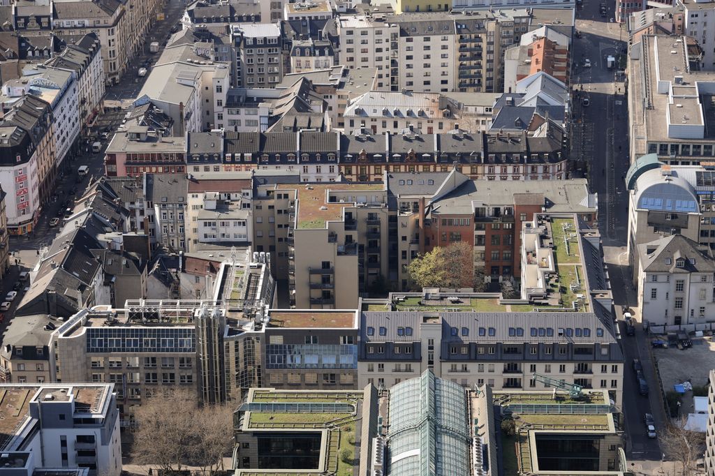 Aerial view showcasing the urban residential neighborhood in Frankfurt am Main, featuring mixed architecture and green rooftops.