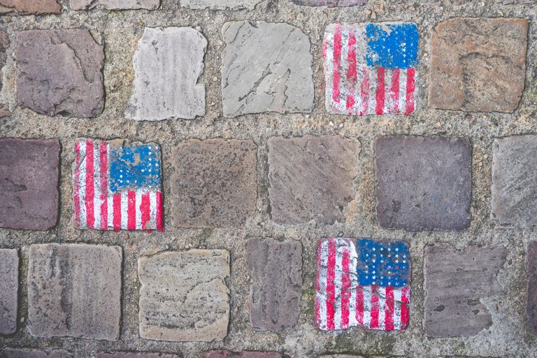 American flag graffiti on old stone wall in Carentan les Marais, Normandy, France.