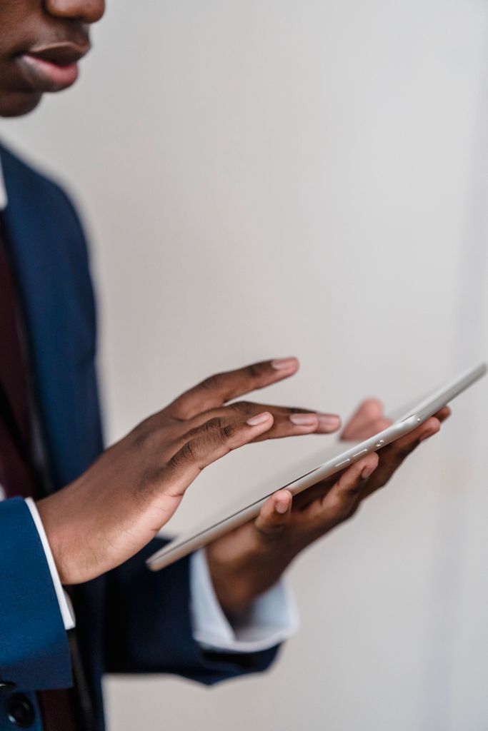 Close-up of a businessman's Business Technology hands using a digital tablet indoors.