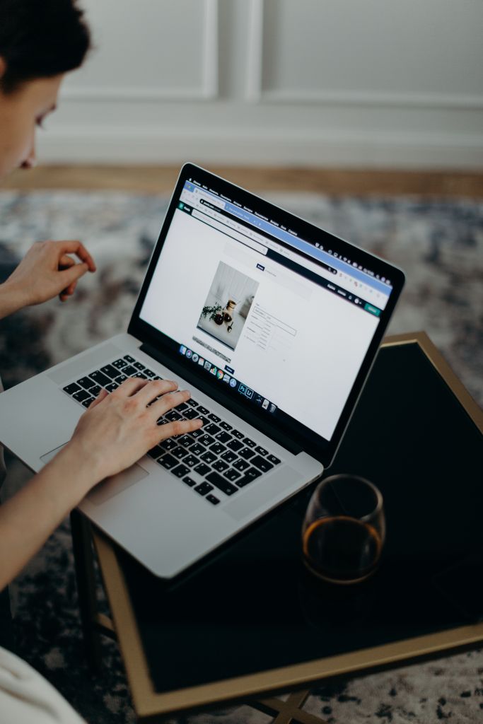 Article Upload Account Close-up of a person working remotely on a laptop indoors. Ideal for remote work or technology themes.