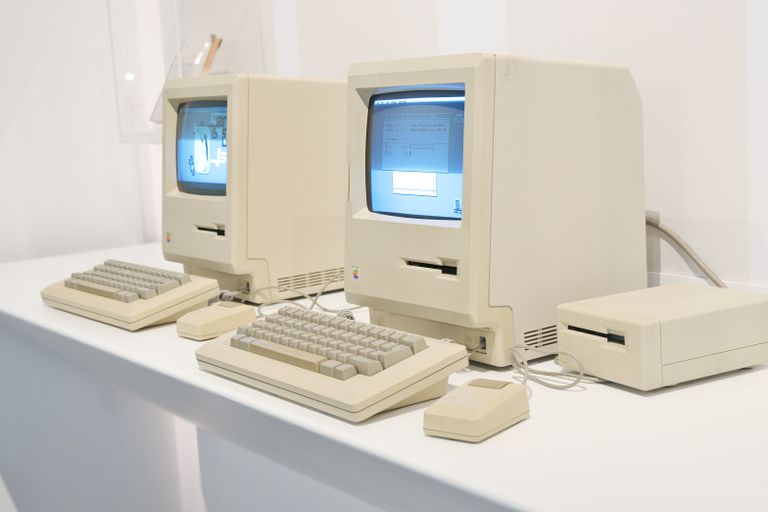 Close-up of retro Apple Macintosh computers showcasing early personal computing history.