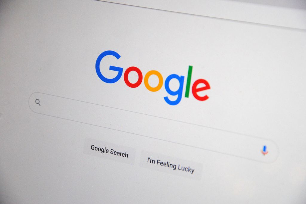 How AI Search Is Changing Google SEO in 2026: Close-up of the Google homepage on a screen showing search options.