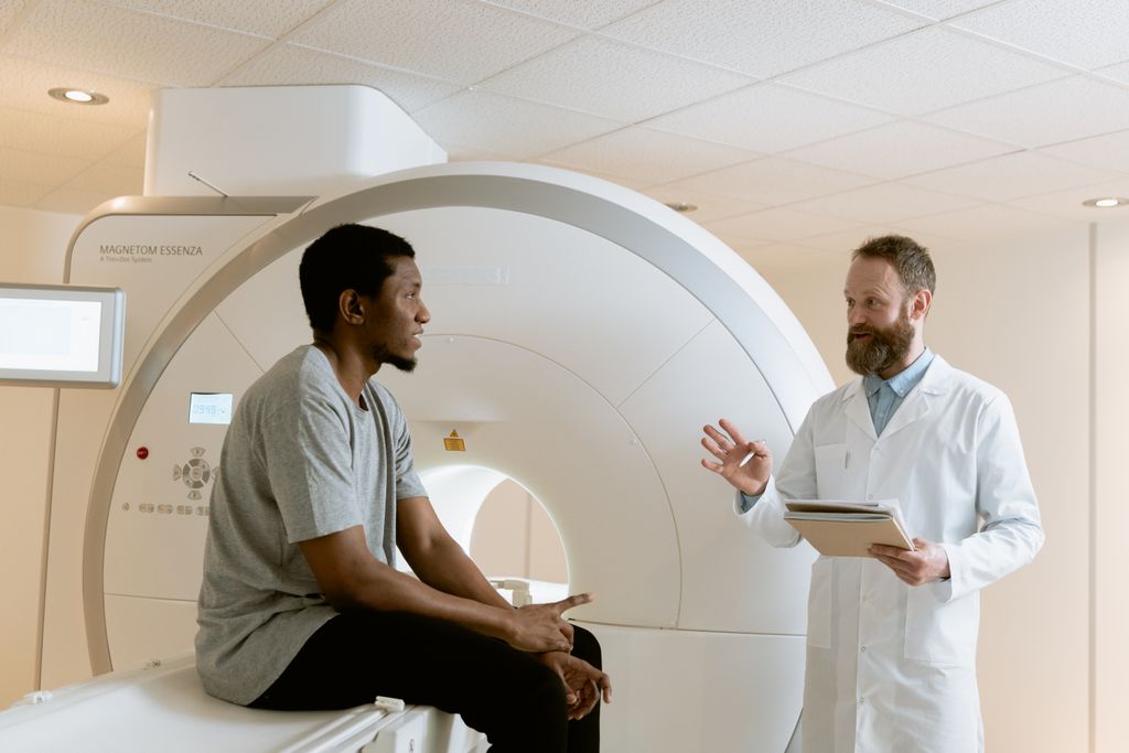 Doctor discussing MRI scan results with patient in a medical facility.