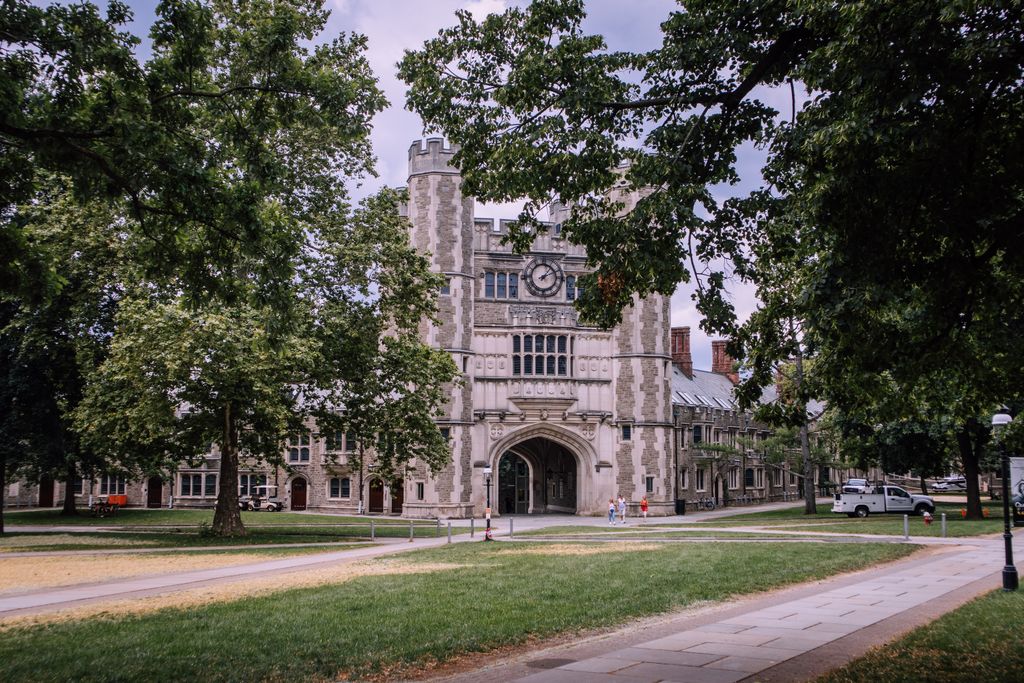 Princeton University Explore the iconic gothic architecture of Princeton University, surrounded by lush greenery.