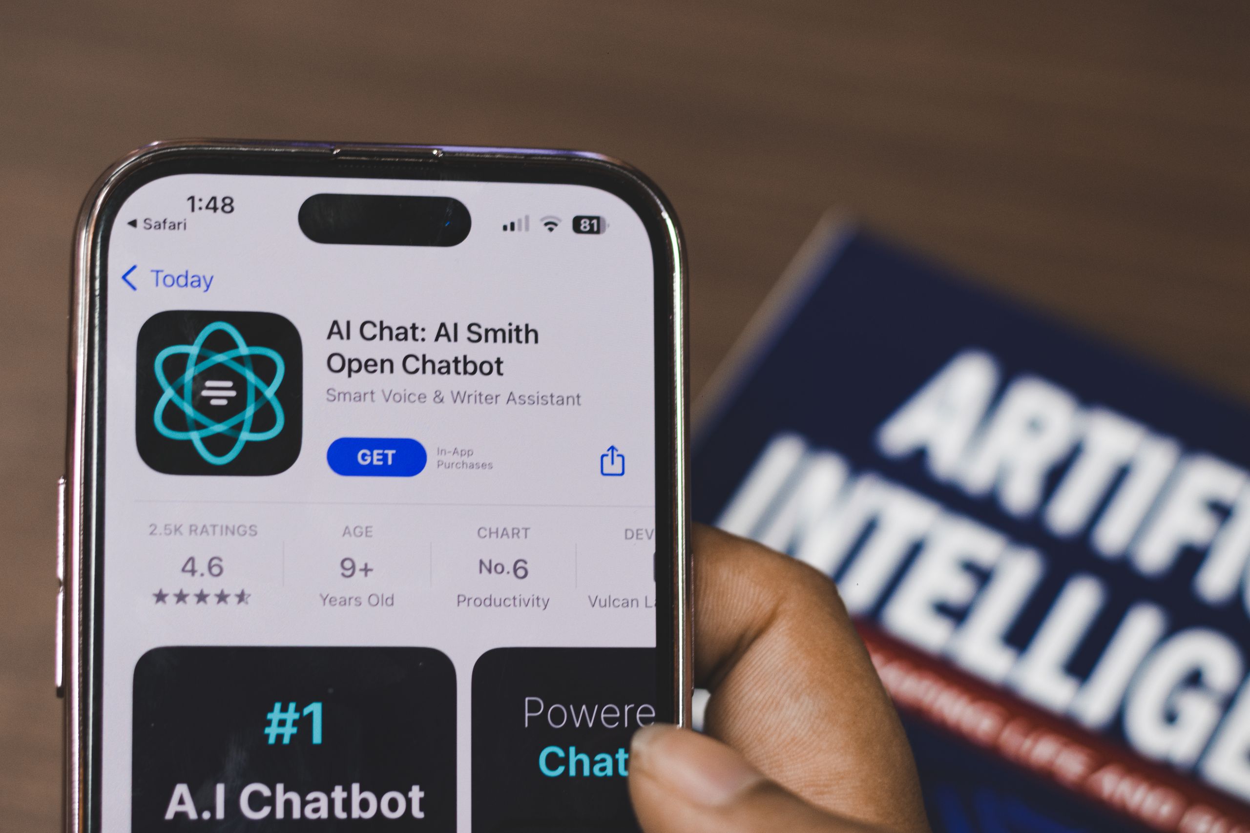 AI Agents vs. Chatbots Hand holding a smartphone with AI chatbot app, emphasizing artificial intelligence and technology.