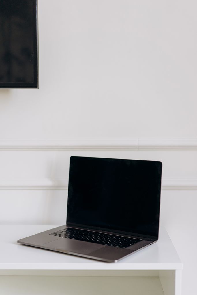 Modern laptop on a clean white table, perfect for tech and workspace themes.