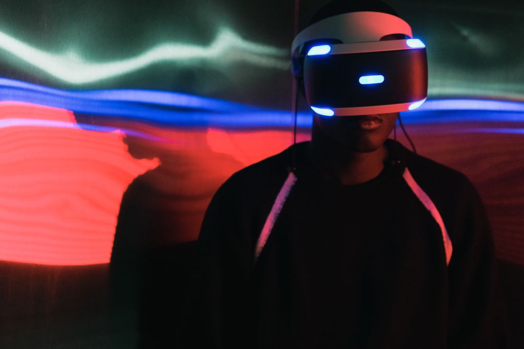Person wearing a virtual reality headset with vibrant light trails in the background.